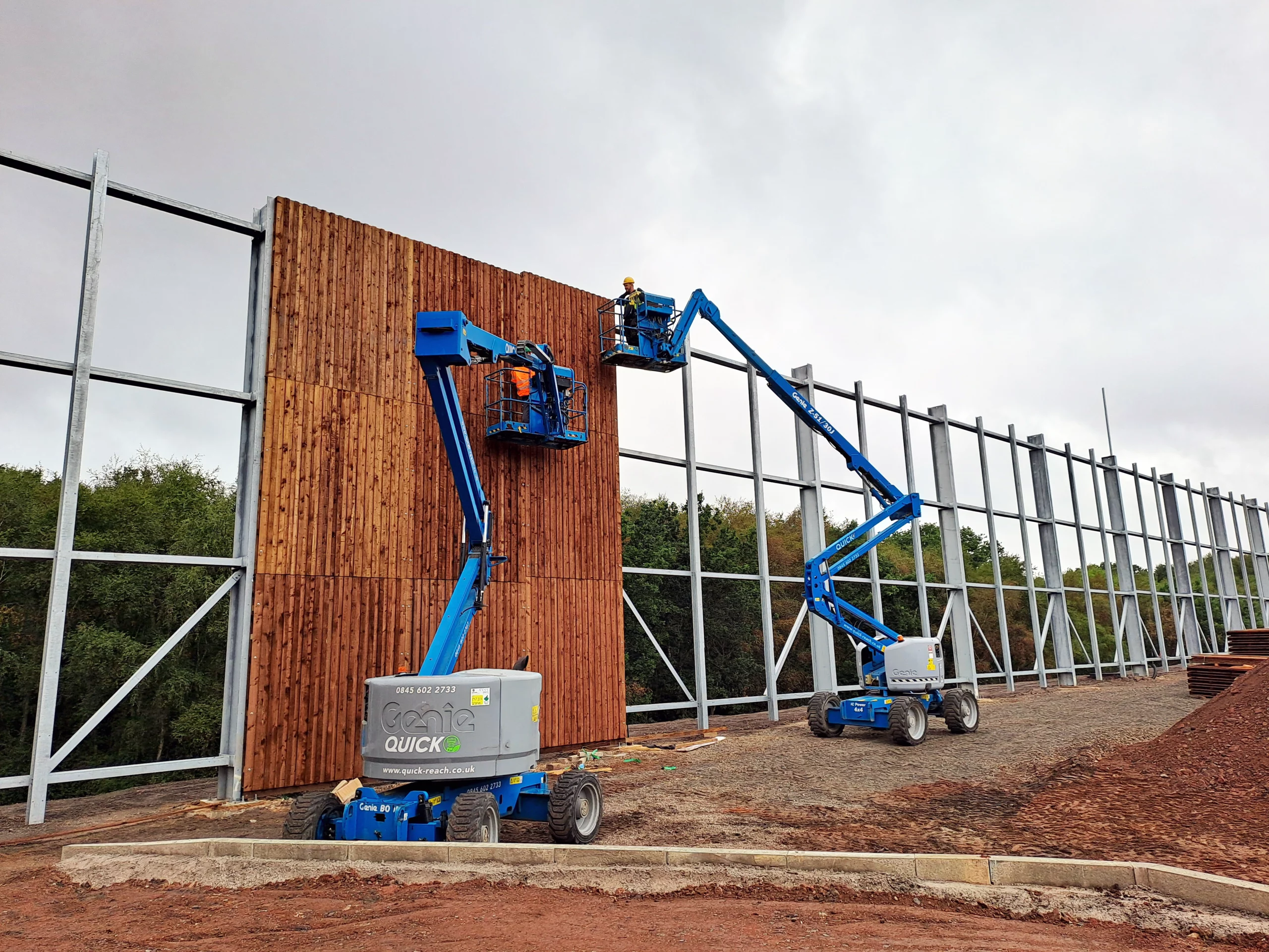 Accredited Fencing Contractors – Procter Fencing & Security Team at Work Procter Fencing & Security engineers installing timber acoustic fencing panels using Genie lifts – ISO 9001 and CHAS accredited contractors.